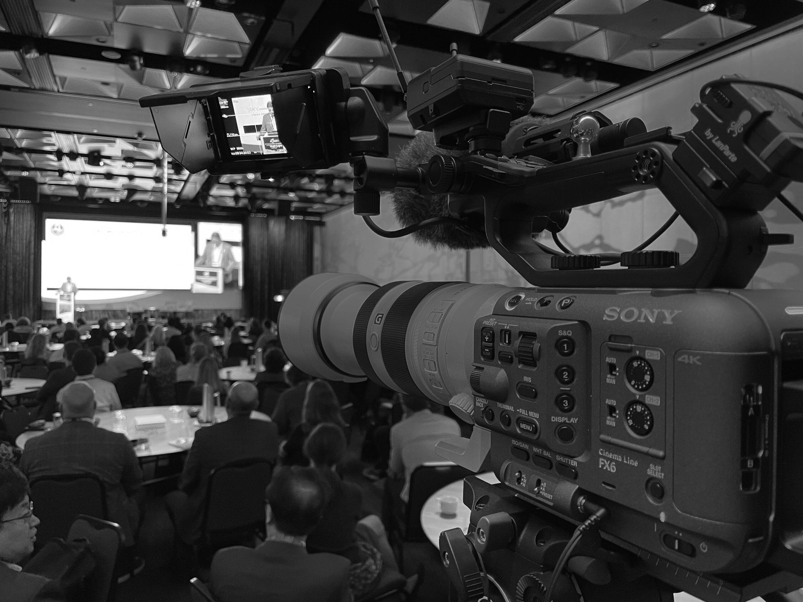 View from behind a camera of filming a large corporate event